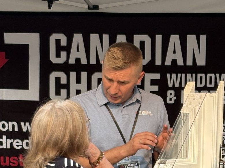 A Canadian Choice specialist showing a window sample to a visitor at the Bridgeland Night Market