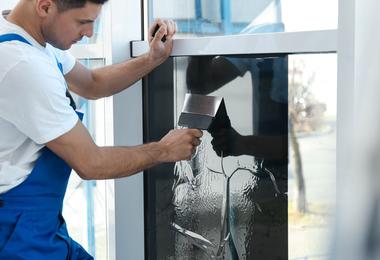 man-installing-and-tinting-window