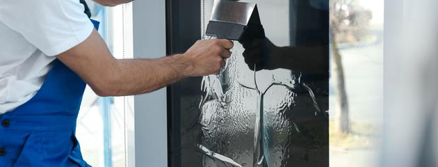 man-installing-and-tinting-window