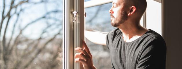 man-in-Scarborough-looking-out-of-newly-replaced-window