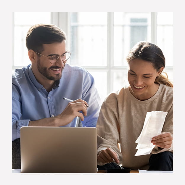 A couple working with a laptop and papers