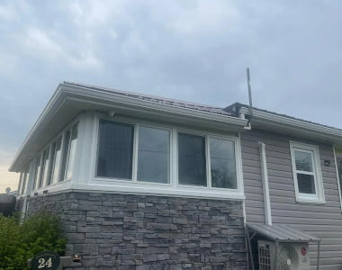 Recent residential window installation project with large energy-efficient windows and exterior home renovation