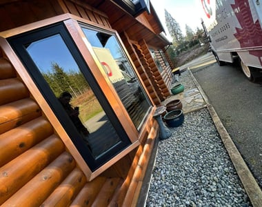 Black bay window installed in a log home in British Columbia