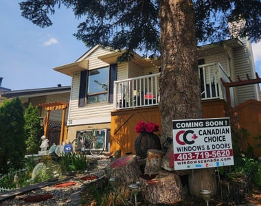 Canadian Choice Windows & Doors project sign in front of a home before window replacement