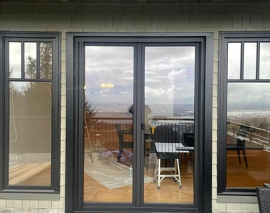 Black double patio door installation on a Vancouver home with mountain and city views
